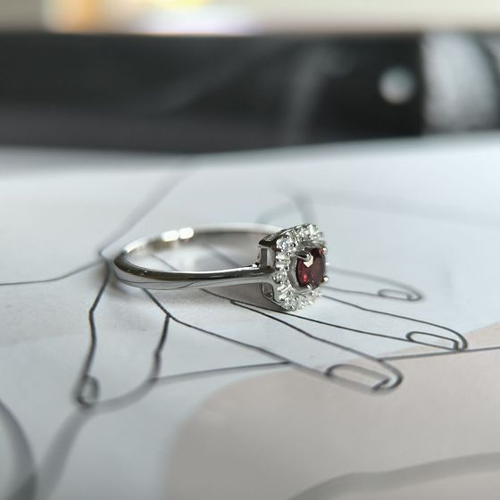 Silver ring with a 0.464-carat garnet and cubic zirconia