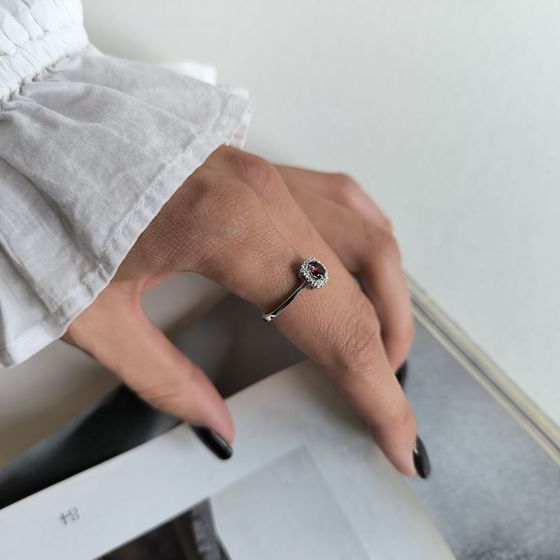 Silver ring with a 0.464-carat garnet and cubic zirconia