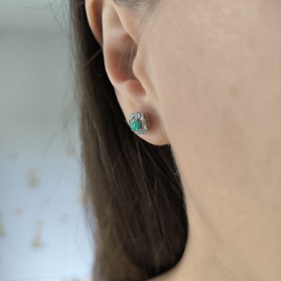 Silver earrings with a 0.682-carat emerald and cubic zirconia