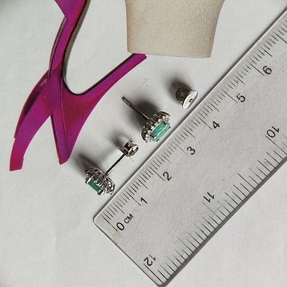 Silver earrings with a 1.814-carat emerald and cubic zirconia