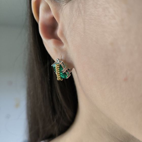 Silver earrings with a 5.963-carat nano emerald