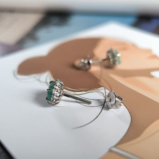 Silver earrings with a 1.814-carat emerald and cubic zirconia